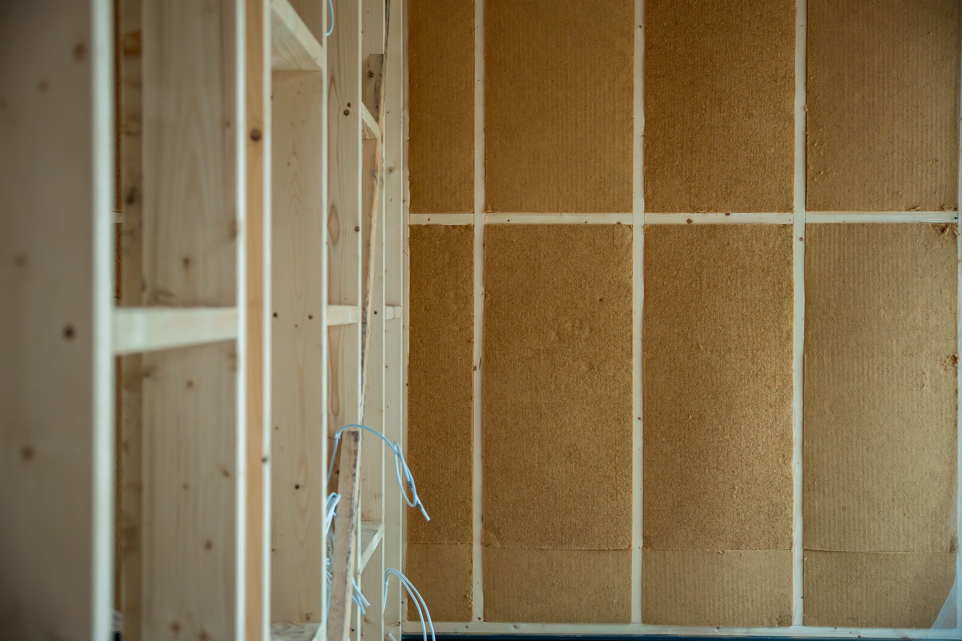 Interior of House Under Construction with Wooden Framing and Insulation
